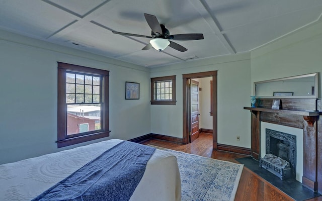 bedroom featuring visible vents, multiple windows, and coffered ceiling