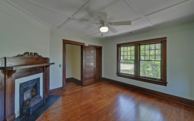 unfurnished living room with a ceiling fan, a fireplace with flush hearth, baseboards, and dark wood finished floors