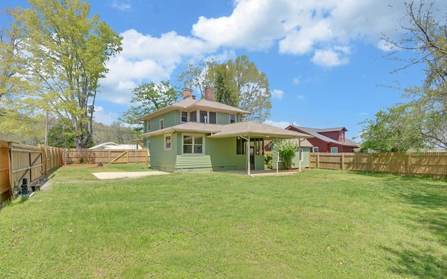 back of property featuring crawl space, a patio, a yard, and a chimney
