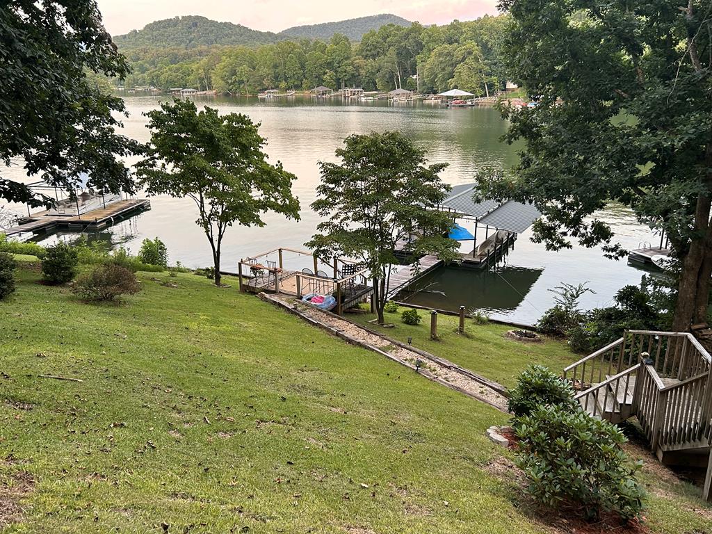 property view of water featuring stairway and a dock