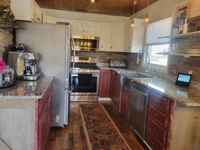 kitchen featuring dark brown cabinets, decorative backsplash, dark wood-style flooring, appliances with stainless steel finishes, and a sink