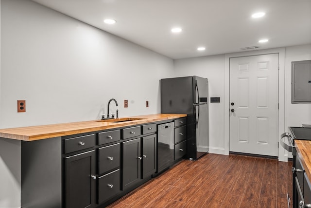 kitchen with visible vents, dark wood-type flooring, a sink, wood counters, and stainless steel appliances