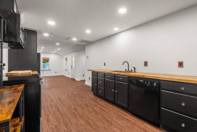 kitchen featuring dark wood-style flooring, a sink, dark cabinetry, wooden counters, and black appliances