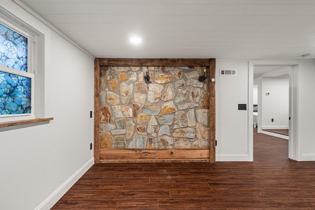 room details with baseboards, visible vents, and wood finished floors