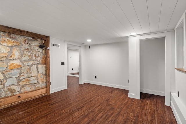 finished below grade area with visible vents, baseboards, and wood finished floors