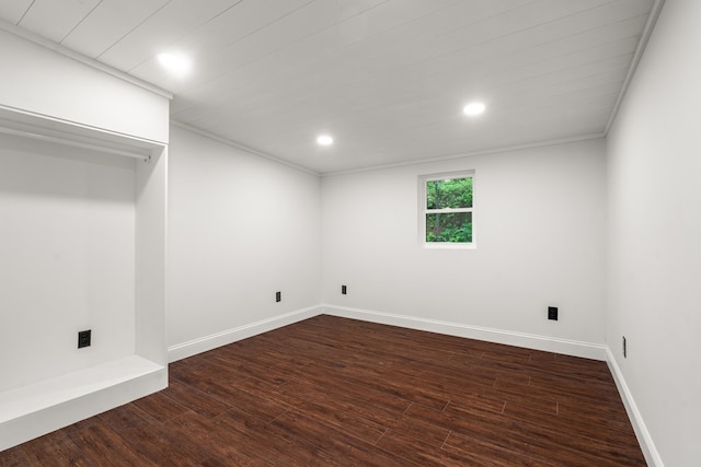 basement featuring recessed lighting, baseboards, ornamental molding, and dark wood finished floors
