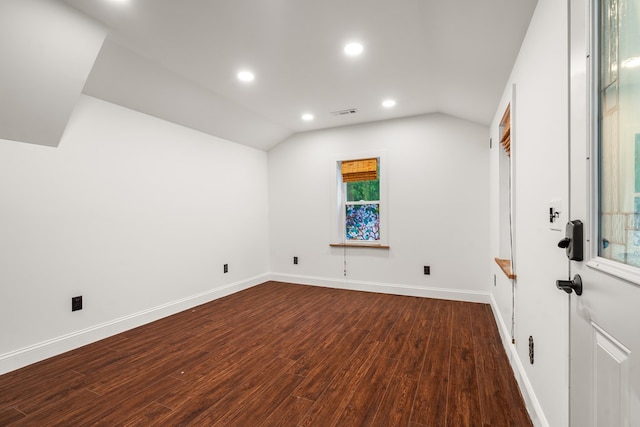 unfurnished room featuring visible vents, baseboards, dark wood-type flooring, recessed lighting, and vaulted ceiling