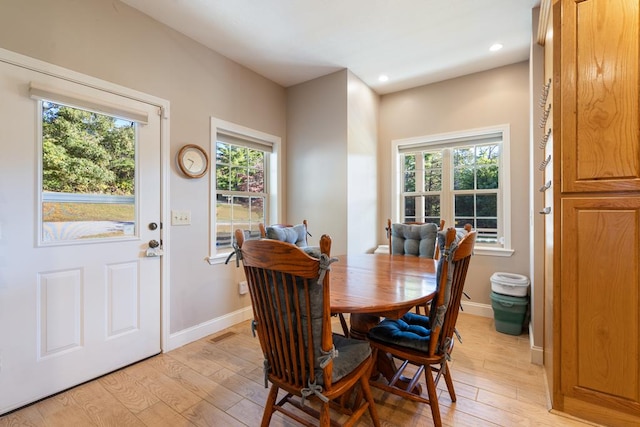 dining space featuring a healthy amount of sunlight and light hardwood / wood-style floors