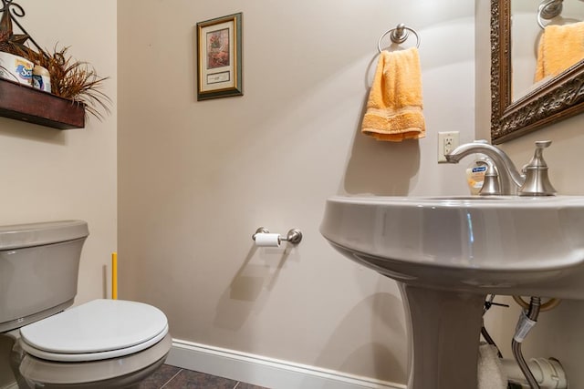 bathroom with tile patterned flooring and toilet