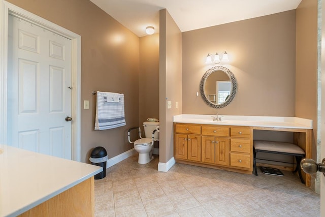 bathroom featuring vanity, tile patterned flooring, and toilet