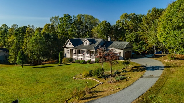 view of front of property with a front yard and a garage