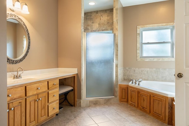 bathroom featuring shower with separate bathtub, tile patterned floors, and vanity