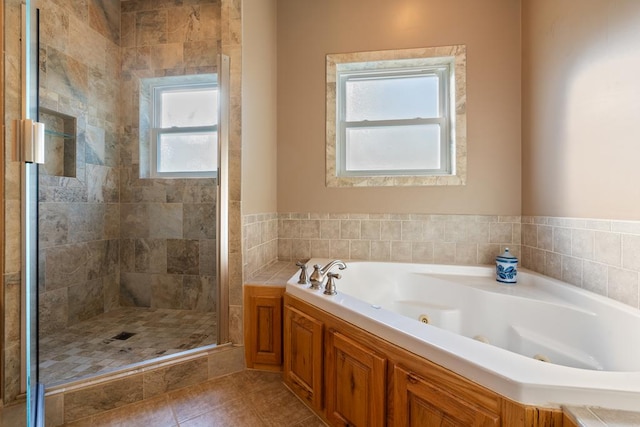 bathroom featuring tile patterned flooring and independent shower and bath