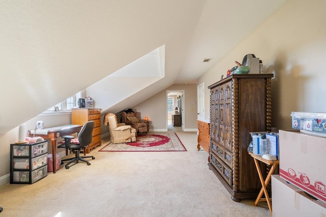 carpeted office featuring lofted ceiling