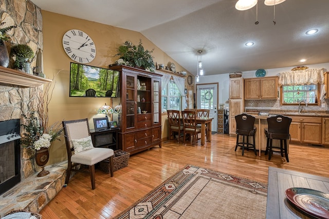 243 Havenwood Ln, Murphy, NC 28906 - living area featuring a fireplace, light wood-style floors, vaulted ceiling, and recessed lighting