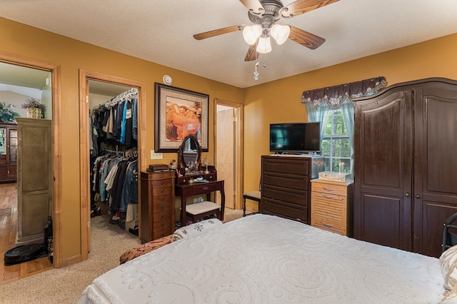 243 Havenwood Ln, Murphy, NC 28906 - bedroom featuring a walk in closet, light carpet, a closet, and a ceiling fan