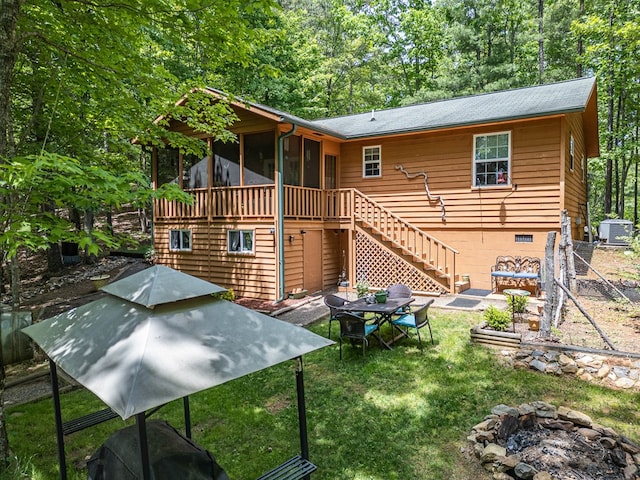 243 Havenwood Ln, Murphy, NC 28906 - back of property with a fire pit, a sunroom, stairs, and central AC unit