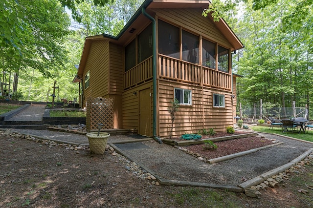243 Havenwood Ln, Murphy, NC 28906 - view of property exterior with a sunroom, a garden, and fence