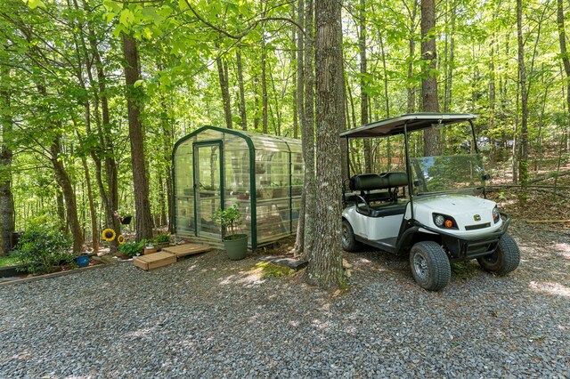 243 Havenwood Ln, Murphy, NC 28906 - view of car parking featuring a greenhouse and a forest view