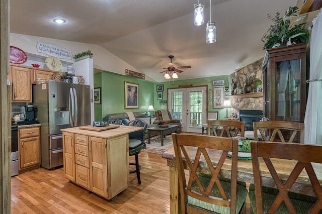 243 Havenwood Ln, Murphy, NC 28906 - kitchen with stainless steel refrigerator with ice dispenser, lofted ceiling, ceiling fan, light wood-type flooring, and a stone fireplace