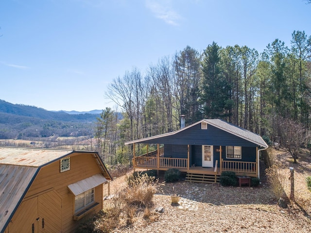 view of front of home featuring covered porch and a mountain view