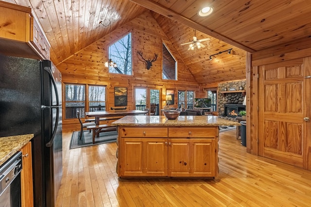 kitchen with light wood-style flooring, a kitchen island, black appliances, and wooden ceiling