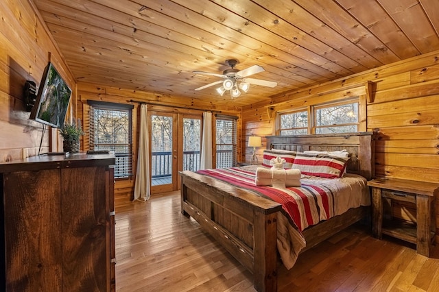 bedroom with wood ceiling, access to exterior, and light wood finished floors