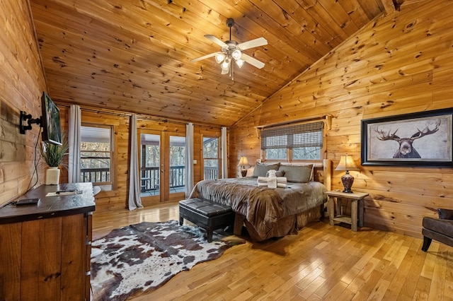 bedroom with light wood finished floors, vaulted ceiling, french doors, wood ceiling, and access to outside