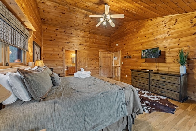 bedroom with high vaulted ceiling, wood ceiling, wood walls, and hardwood / wood-style flooring