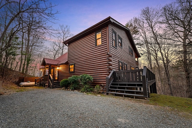 exterior space with a wooden deck and metal roof