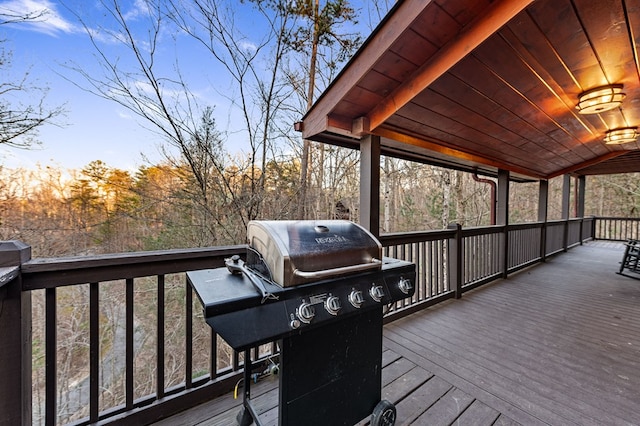 wooden terrace with a grill