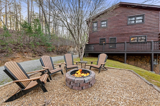 view of yard featuring a deck and a fire pit