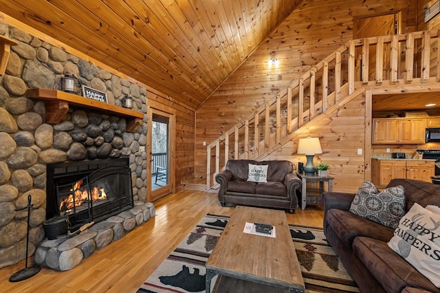 living room featuring light wood-type flooring, wooden ceiling, stairs, and vaulted ceiling