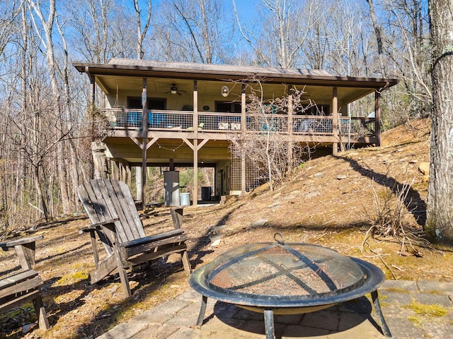 rear view of property featuring central AC unit, ceiling fan, and a patio area