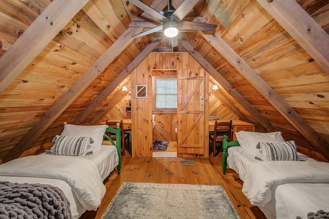 bedroom featuring wood ceiling, wooden walls, lofted ceiling with beams, and light wood-type flooring