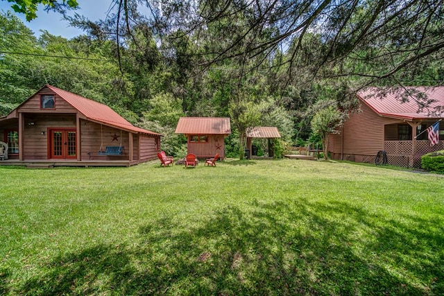 view of yard with an outbuilding and french doors