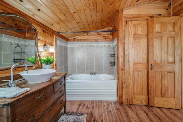 bathroom featuring hardwood / wood-style floors, lofted ceiling, a tub to relax in, vanity, and wooden ceiling