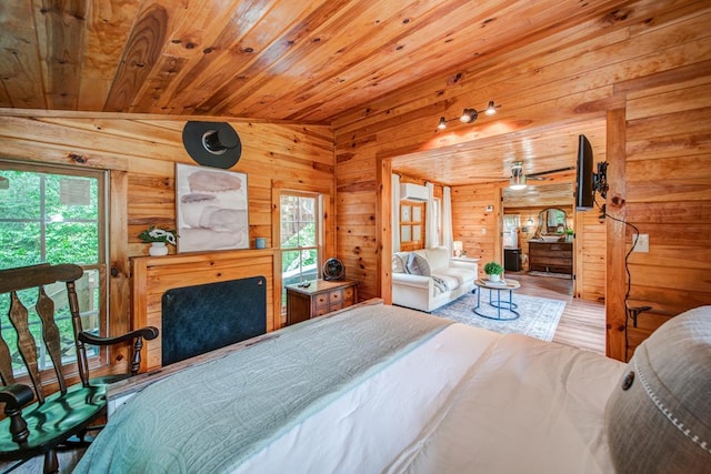 bedroom featuring wood-type flooring, multiple windows, and wooden ceiling