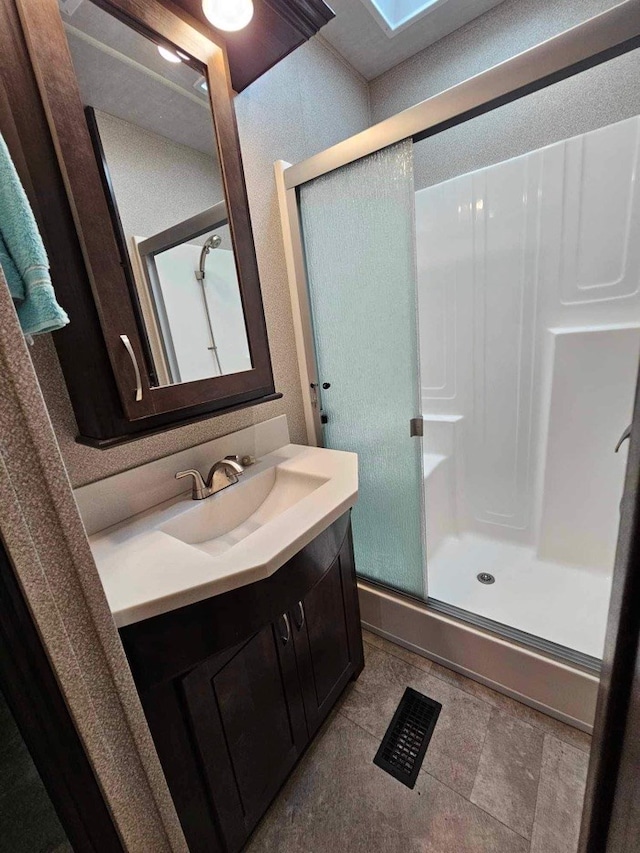 bathroom with vanity and an enclosed shower