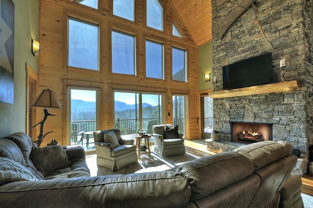 living area with lofted ceiling, a fireplace, wood finished floors, and wooden ceiling