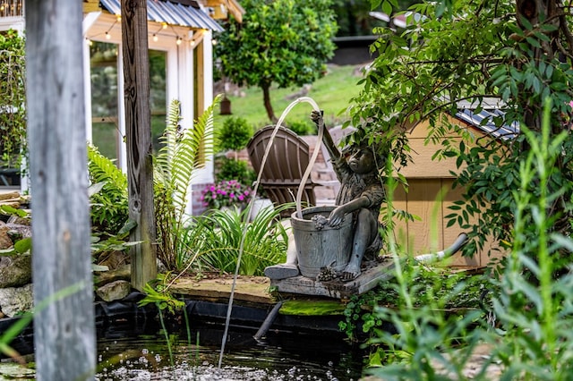 view of yard featuring a small pond