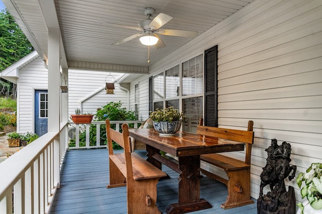 wooden deck featuring a ceiling fan