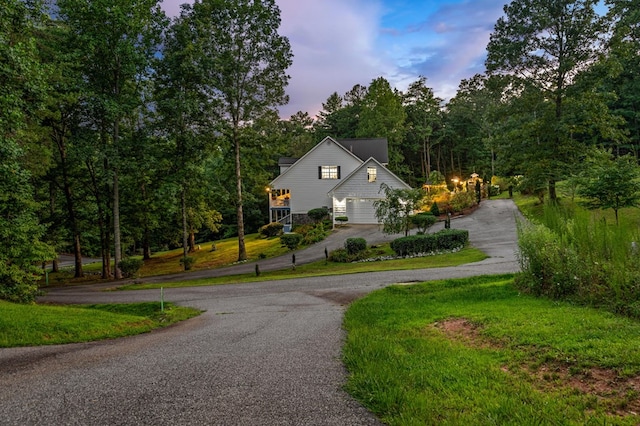 exterior space featuring a garage and aphalt driveway