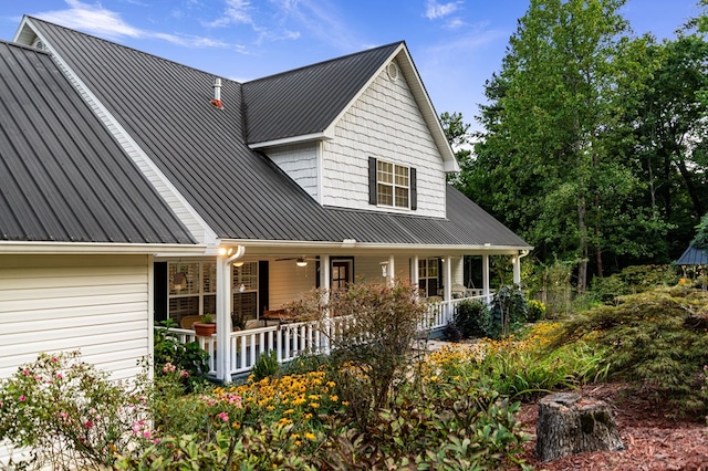 view of front facade featuring metal roof, a porch, and a standing seam roof