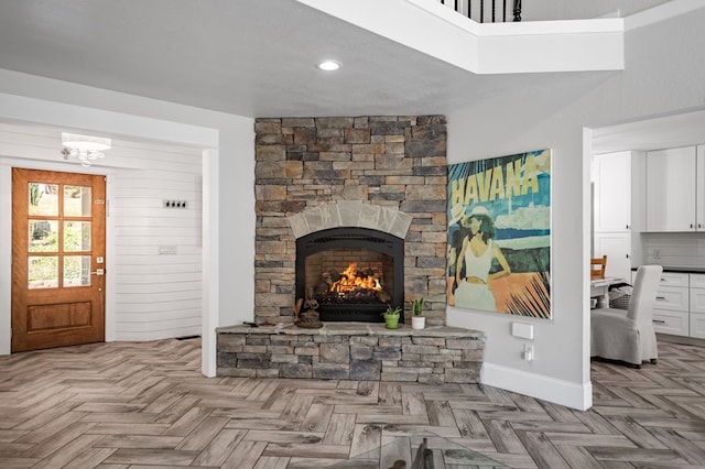 living room with a fireplace, wooden walls, and a high ceiling