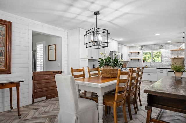 dining space with wood walls and recessed lighting