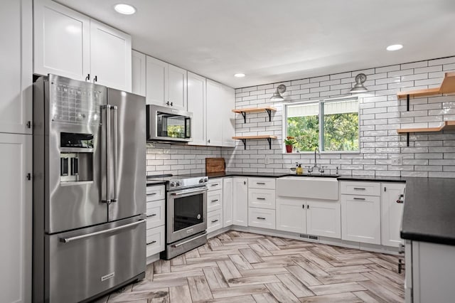 kitchen with dark countertops, a sink, stainless steel appliances, open shelves, and backsplash