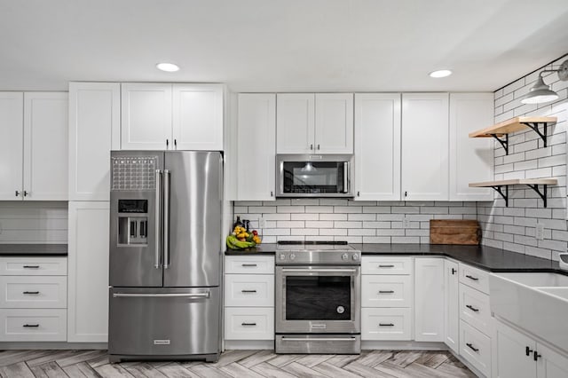 kitchen featuring open shelves, dark countertops, white cabinetry, and stainless steel appliances