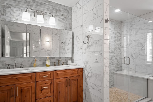 bathroom featuring double vanity, a shower stall, tasteful backsplash, and a sink