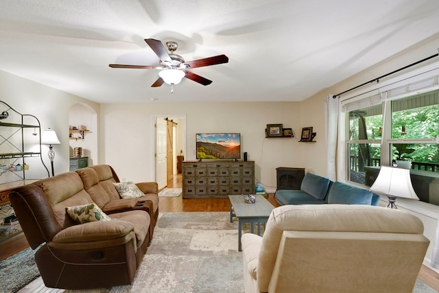 49 Hampton Ln, Hayesville, NC 28904 - living room featuring light wood-style flooring, a ceiling fan, and arched walkways